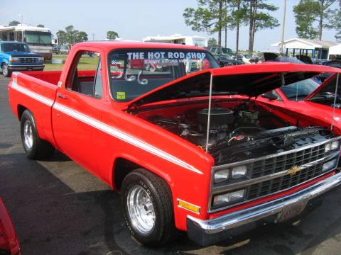 1992 Ford Mustang - Red pickup truck with hood open, displaying its engine and a white stripe along the side.