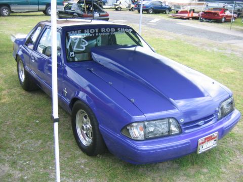 1992 Ford Mustang - Purple 1992 Ford Mustang drag car parked on grass with "The Hot Rod Shop" sticker on windshield.
