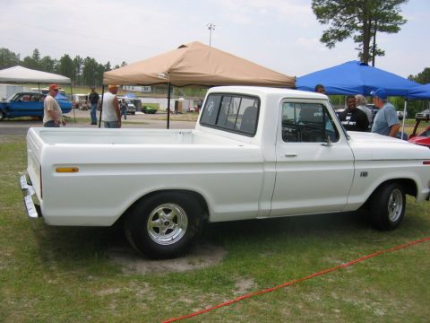 1992 Ford Mustang - This white pickup truck, likely a 1979 Ford F-150, is parked on grass at an outdoor event.