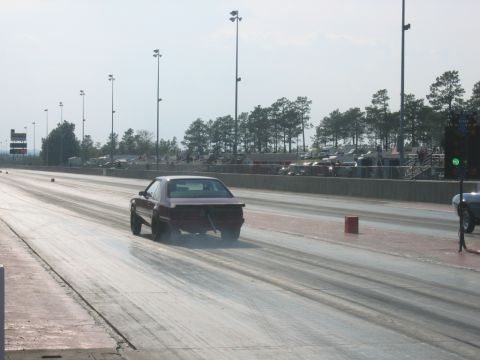 1992 Ford Mustang - 1992 Ford Mustang on the drag strip, rear view, with smoke trailing.