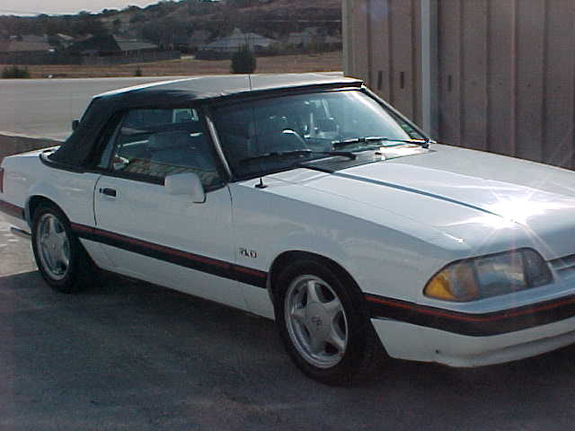 White 1989 Ford Mustang convertible parked outdoors