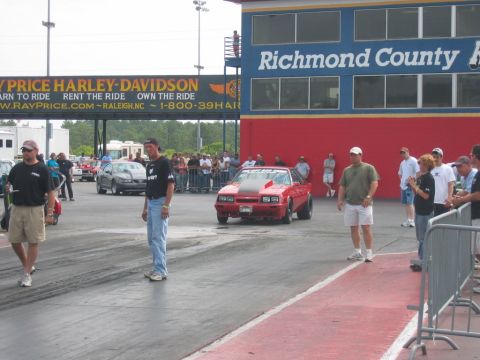 1992 Ford Mustang - Red drag car with hood scoop and black stripe on hood at Richmond County drag strip.