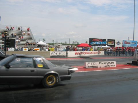 1992 Ford Mustang - A 1992 Ford Mustang is seen on the drag strip at Rockingham Dragway, with spectators watching from the stands.