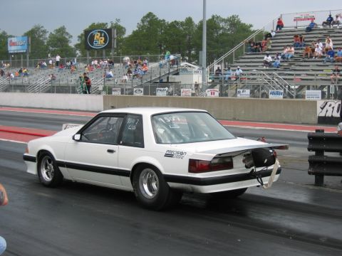 1992 Ford Mustang - White 1992 Ford Mustang drag car on the track with racing slicks and a spoiler.