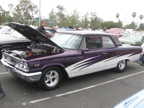 1968 Ford Mustang - A customized 1963 Ford Galaxie with its hood up is displayed at an outdoor car show.