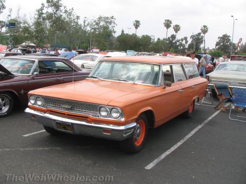 1968 Ford Mustang - This orange station wagon, likely a 1963 model, is parked at an outdoor car show.