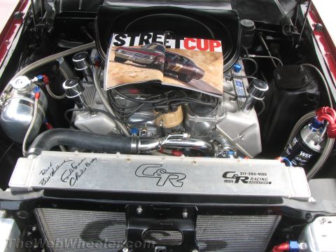 1968 Ford Mustang - Engine bay details with a magazine cars placed on top of the engine.