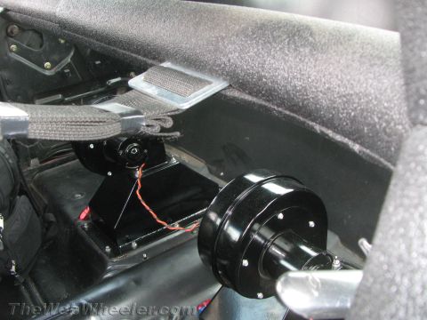 1968 Ford Mustang - Close-up of seatbelt hardware and wiring in a car's interior.