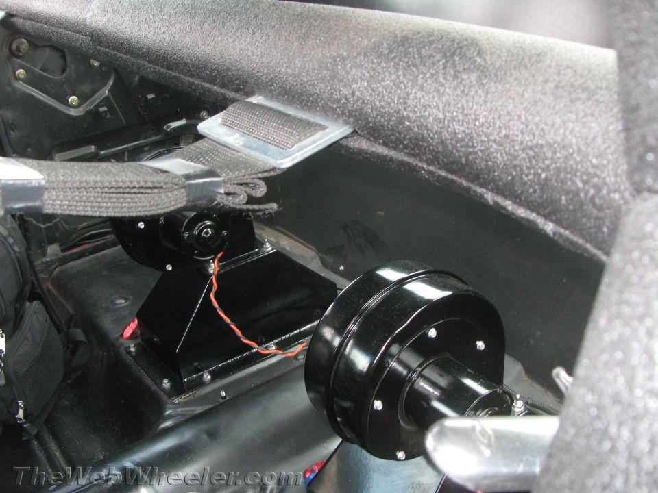 Aftermarket seatbelt mounting hardware attached to car interior