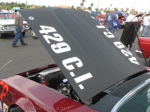 1968 Ford Mustang - Close-up of a car hood with "429 C.I." painted on it, revealing engine parts.
