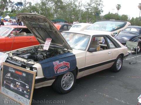 1968 Ford Mustang - A beige Ford Capri Turbo RS is displayed with its hood open at an outdoor car event.