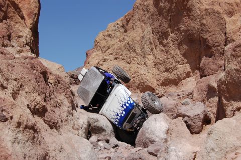 1985 Ford Bronco - An off-road vehicle has tipped onto its side while navigating a treacherous rocky canyon.