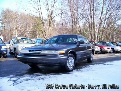 2001 Ford Crown Victoria - This 1997 Ford Crown Victoria police car is parked in a lot with other vehicles during winter.