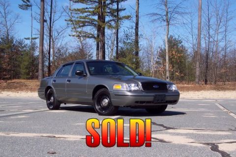 2001 Ford Crown Victoria - This gray 2001 Ford Crown Victoria is shown from the front three-quarter view, with a "SOLD!" graphic overlaid.