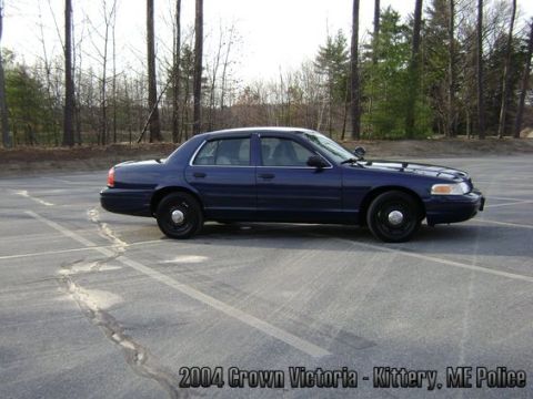 2001 Ford Crown Victoria - Side view of a dark blue police sedan, identified as a 2004 Crown Victoria from Kittery, ME Police.