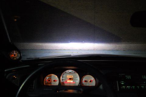 1985 Mercury Grand Marquis - Interior view of a 1985 Mercury Grand Marquis, dashboard illuminated, headlights on.