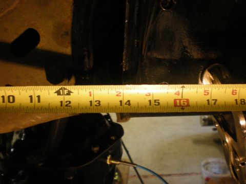 1993 Ford Bronco - A yellow measuring tape is used to measure a part of a vehicle, with text from supermotors.net visible.