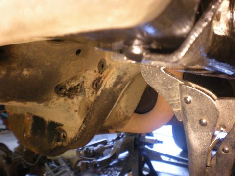 1993 Ford Bronco - Close-up view of vehicle undercarriage suspension components, including a clamp and the Supermotors logo.