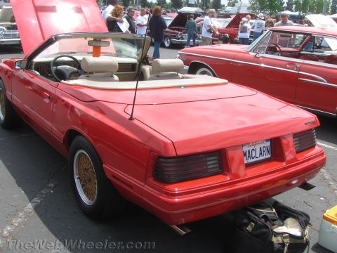 1968 Ford Mustang - This red convertible, likely a 1987 Ford Mustang, is seen from the rear at a car show.