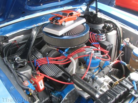 1968 Ford Mustang - A detailed view of a 1968 Ford Mustang engine bay, a miniature replica of the car.