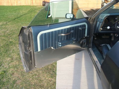 1974 Ford Ranchero - The interior of a 1974 Ford Ranchero shows a blue vinyl door panel and dashboard details.