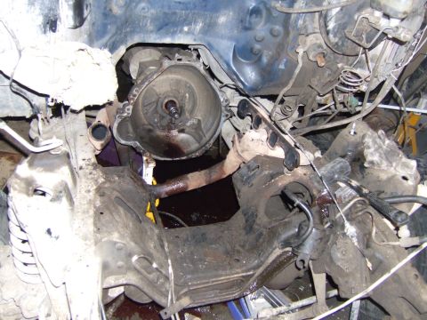 1989 Ford Bronco - Engine and transmission components are visible in this close-up view of a vehicle's undercarriage.