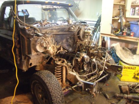 1989 Ford Bronco - This Ford truck is in a state of disassembly, with its engine removed and the chassis exposed.
