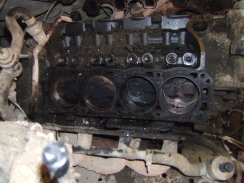 1989 Ford Bronco - Close-up view of an engine block, revealing pistons and cylinder heads.