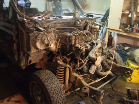 1989 Ford Bronco - This Ford Bronco is in a state of disassembly, with its engine and front-end components exposed for work.