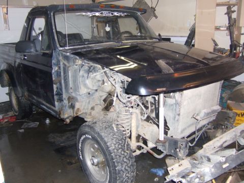 1989 Ford Bronco - This vehicle is missing its front grille and bumper, with exposed engine parts and suspension visible.