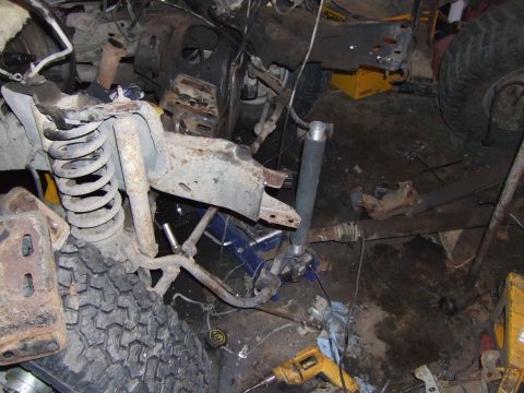 1989 Ford Bronco - The front suspension and tire of a 1989 Ford Bronco are visible in this image.