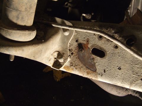1989 Ford Bronco - Close-up view of a vehicle's undercarriage, showing frame and suspension components.