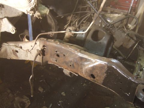 1989 Ford Bronco - Close-up of a heavily rusted vehicle frame and engine components, suggesting a project in progress.