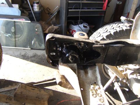 1989 Ford Bronco - This image shows a close-up view of a vehicle's frame and suspension system, with various mechanical parts visible.