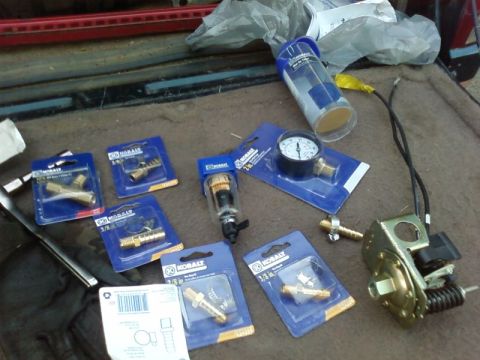 1995 Ford Bronco - Various air compressor fittings and a pressure gauge are displayed.