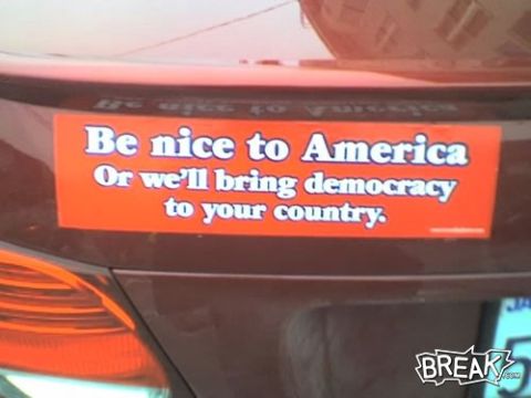 1996 Ford Bronco - An orange bumper sticker with white text is affixed to the rear of a brown car.