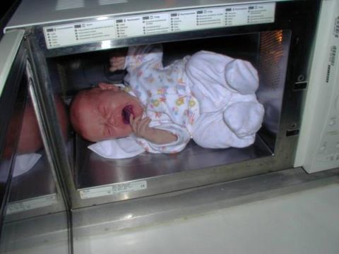 1996 Ford Bronco - A baby is placed inside a microwave oven, with the door open.