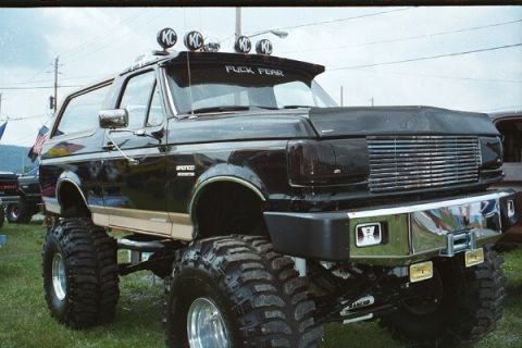 1981 Ford Bronco - This heavily modified Ford Bronco features oversized tires and KC lights, with a custom visor message.