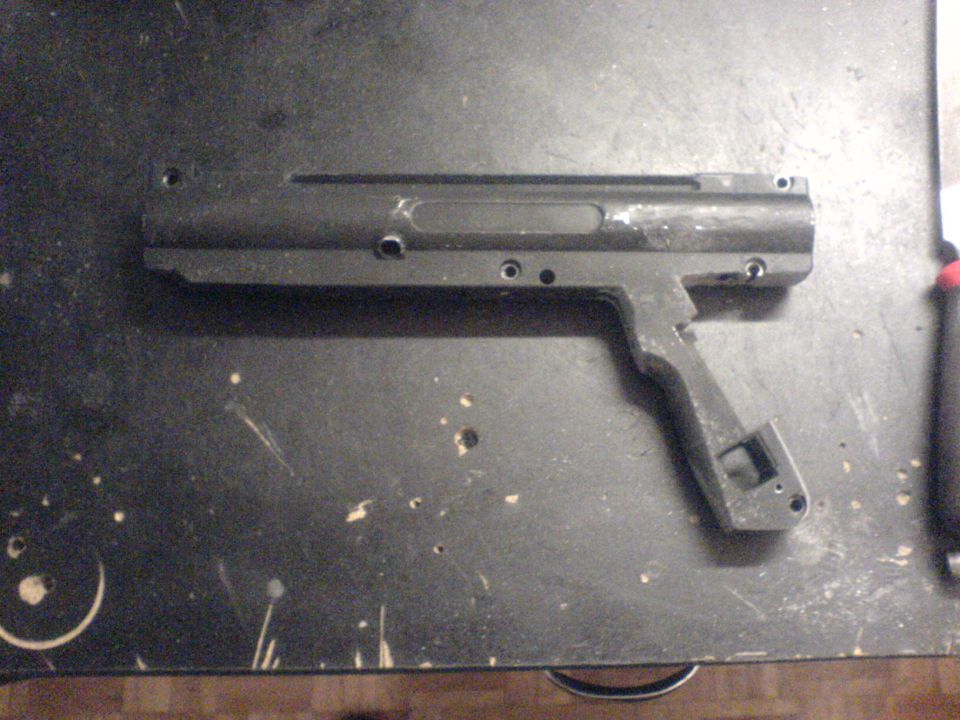 Black non-vehicular component with pistol grip on a dark surface