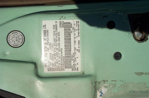 2001 Ford Crown Victoria - Vehicle identification label shows a manufacturing date of July 1999.