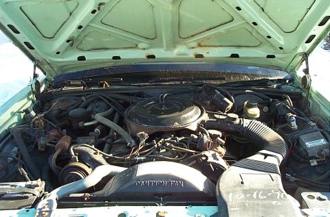 2001 Ford Crown Victoria - Engine bay of a vehicle, showing the V8 engine and associated components. A date is marked on the fan shroud.