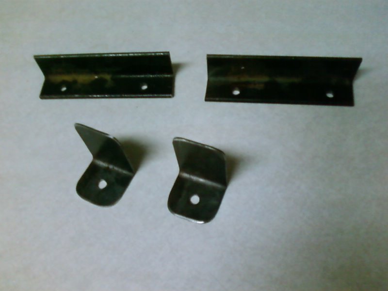 Brackets for top and bottom (ones for bottom are on top in pic)
Bottom bracket is 1/8 x 1 steel angle.
Top bracket is 16ga bent to 90.