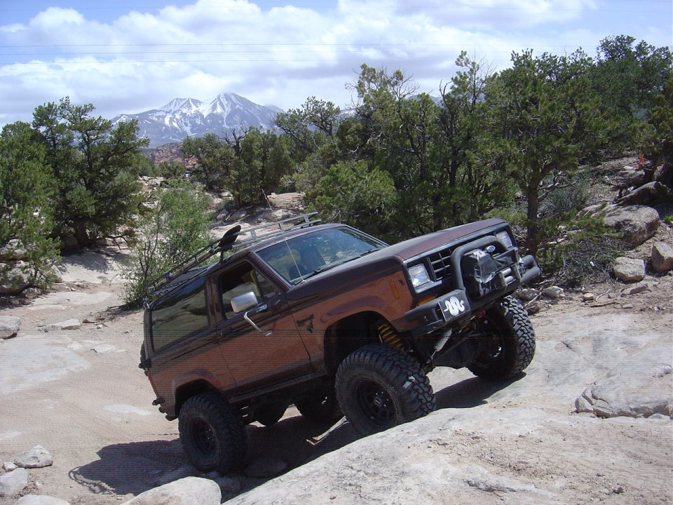 1986 Ford Bronco II off-roading on a rocky trail.