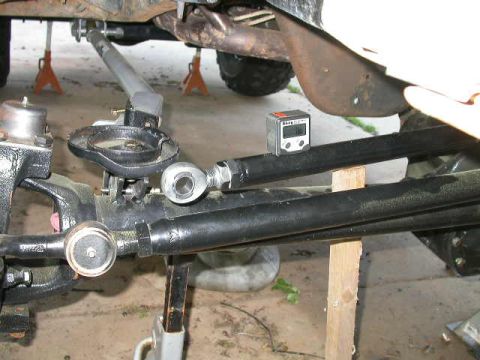 1990 Ford Bronco - Suspension fabrication in progress: black tubular radius arms/links with heim joints mocked up to a front axle on jack stands, with a digit…