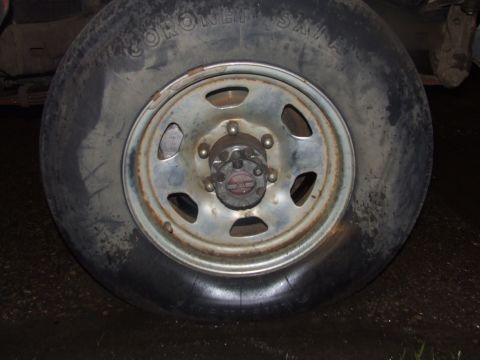 1990 Ford Bronco - Close-up view of a vehicle's wheel, showing the tire and rim details.
