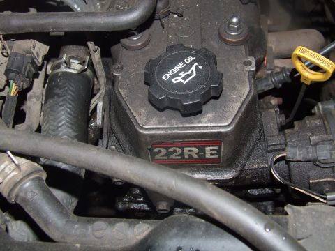 1990 Ford Bronco - Close-up view of an engine bay, showing various components and a prominent oil cap.