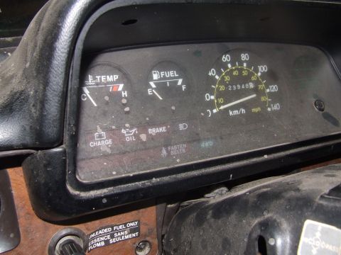 1990 Ford Bronco - Interior view of a vehicle's dashboard, showing various gauges and indicator lights.