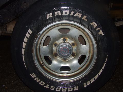 1990 Ford Bronco - Close-up of a tire and wheel assembly, showing tire brand and a Toyota center cap.