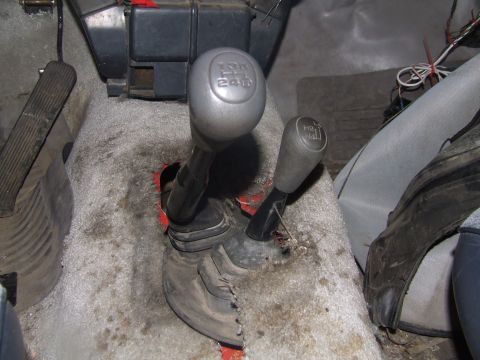 1990 Ford Bronco - The interior of a vehicle shows two gear shifters, one of which is labeled for 4WD operation.