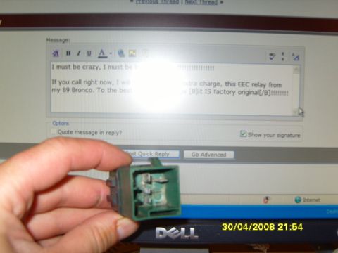 1989 Ford Bronco - A hand holds a green electrical relay in front of a computer screen displaying a forum discussion.